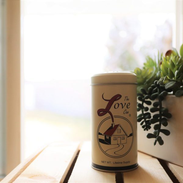 The Love Can next to plants