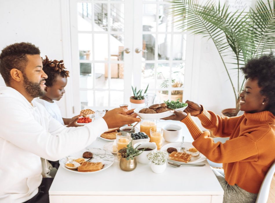 African American family of three eating breakfast