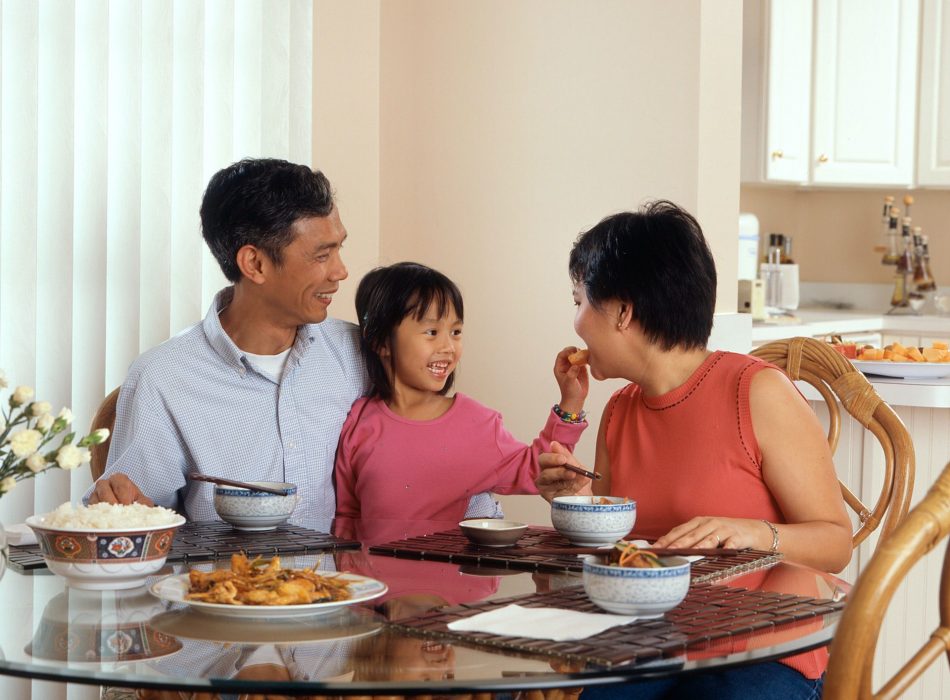Asian family of three enjoying a meal